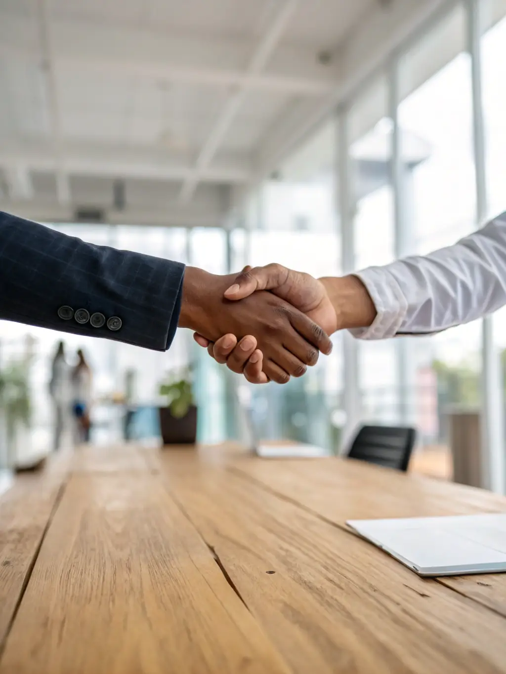A handshake between a lender and a business owner, representing the loan approval and closing process.