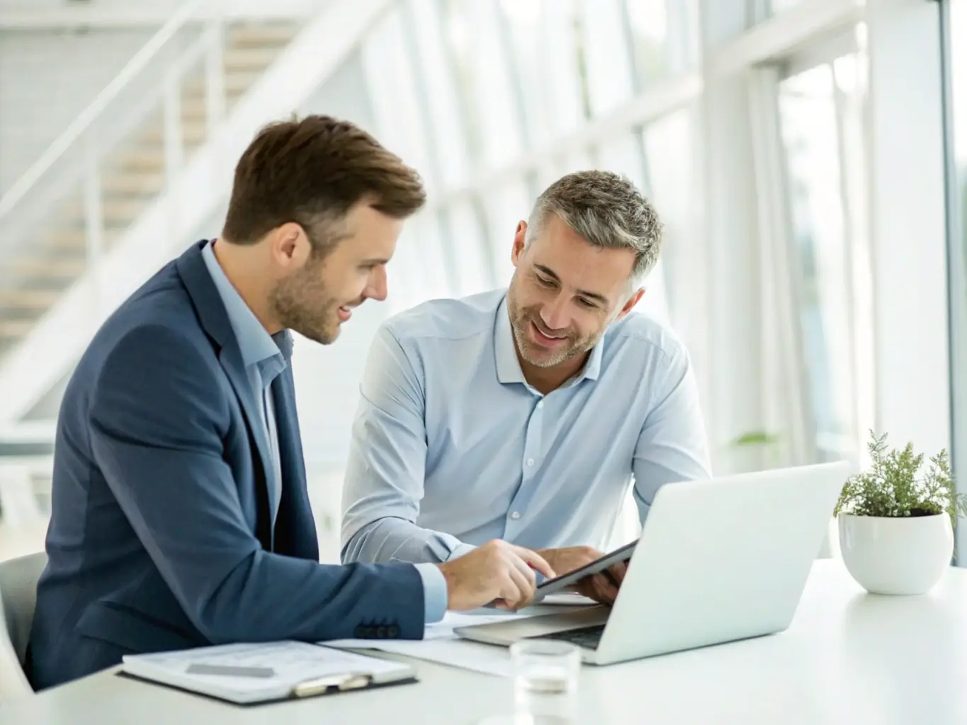 A professional financial consultant in a modern office setting, reviewing financial documents and discussing loan options with a business owner, showcasing personalized service.
